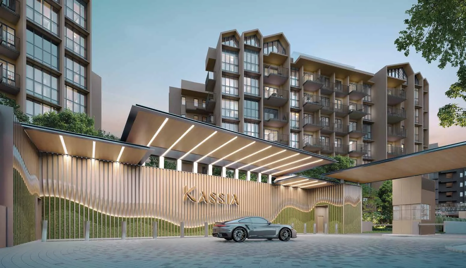Kassia, artist’s impression: the Arrival Court at dusk, a long canopy with lit ribs over the drive and a curving slatted screen bearing the Kassia name, with a block rising behind